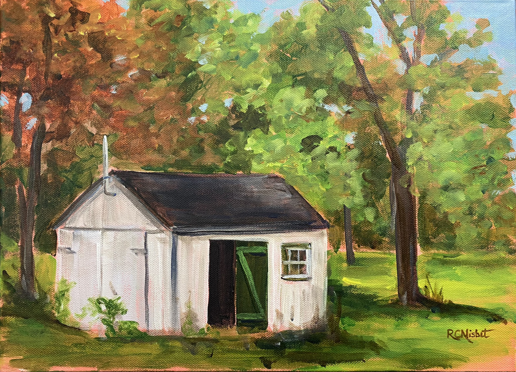 Small out building with green door. There are colour autumn trees in behind it.