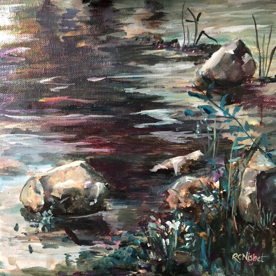 A few rocks nestled along a shoreline.